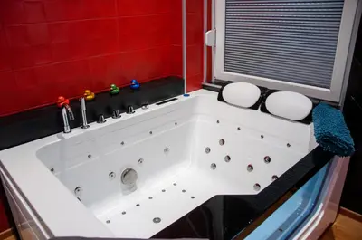 a large white bath tub in a red bathroom at Vip room 209 in Trooz