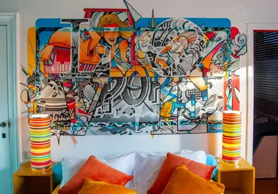 a painting on the wall of a room with a couch at Vip room 209 in Trooz