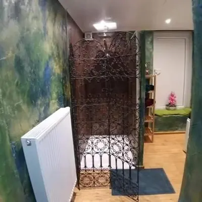 a iron gate in a room with a wall at Vip room 209 in Trooz