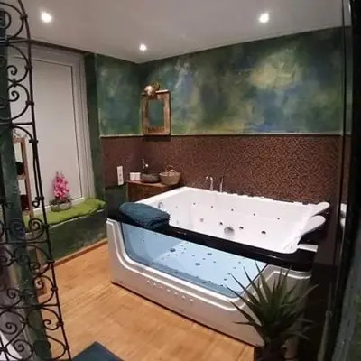 a bath tub in a bathroom with a painting at Vip room 209 in Trooz