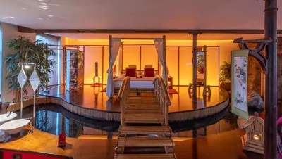 a house with a swimming pool and a wooden staircase at Le Baiser de Shogun in Ensival