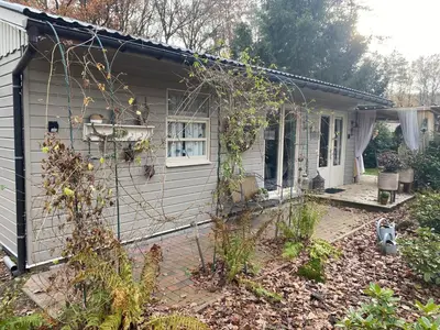 a small house with a fence in front of it at Chalet Sint Barbara in Zutendaal