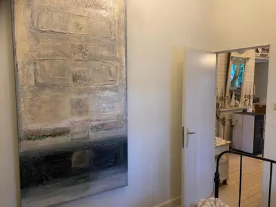 a painting hanging on a wall in a room at Chalet Sint Barbara in Zutendaal
