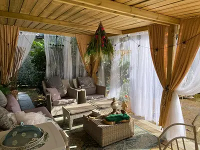 a living room with a couch and a table at Chalet Sint Barbara in Zutendaal
