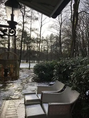a group of chairs and a gazebo in a park at Chalet Sint Barbara in Zutendaal