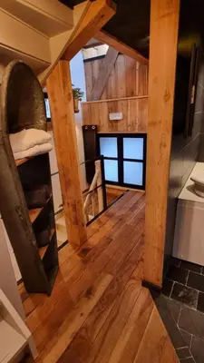 a view of a room with wood flooring and a staircase at Een vleugje wellness in de Voerstreek - Bed & Brocante Onder de Poort in Voeren