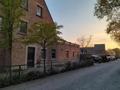 a brick building on the side of a street at B&B De Floreffe in Overpelt