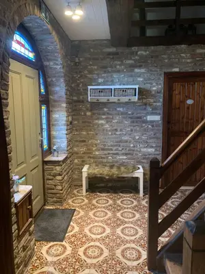 a room with a staircase and a stone wall at B&B Dageraad in Bocholt