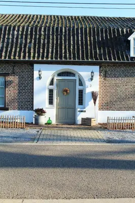 a house with a blue door on a street at B&B Dageraad in Bocholt