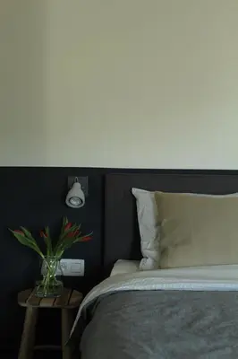 a bedroom with a bed with a white light above it at B&B Dageraad in Bocholt