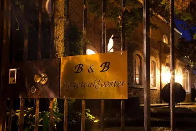 a sign that reads b b antiquated house at B&B Het Agnetenklooster in Maaseik