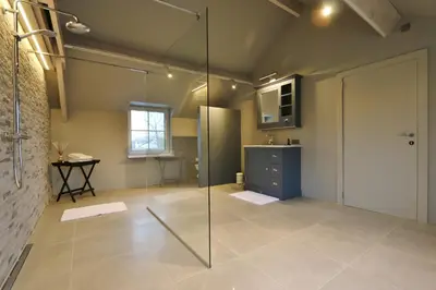 a bathroom with a shower and a glass door at AMADIS in Kesselt
