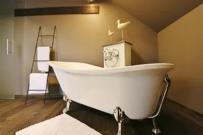 a white bath tub sitting in a room at AMADIS in Kesselt