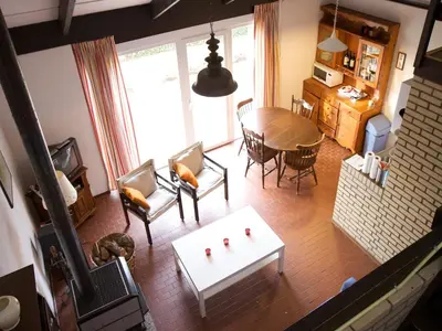 an aerial view of a living room with a table and chairs at Holiday Home in Gemmenich with Forest Views in Ten Eiken