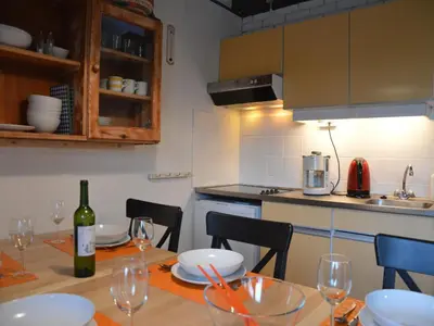 a kitchen with a table with a bottle of wine at Holiday Home in Gemmenich with Forest Views in Ten Eiken