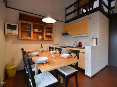 a kitchen with a wooden table and chairs in a room at Holiday Home in Gemmenich with Forest Views in Ten Eiken