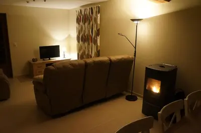 a living room with a couch and a lamp at Holiday home La ferme brabant in Voeren
