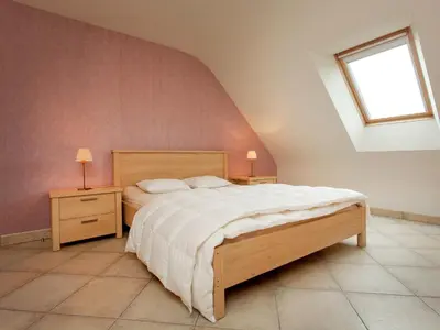 a bedroom with a large bed and a window at Peer Villa with Garden in Peer