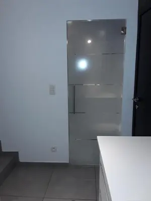 a kitchen with white walls and a refrigerator at Hébergement Les Heros in Liège