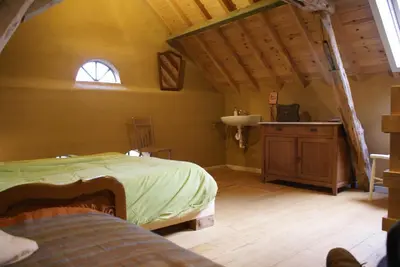 a bedroom with a bed and a sink in a room at B&B De Metstermolen in Sint-Truiden