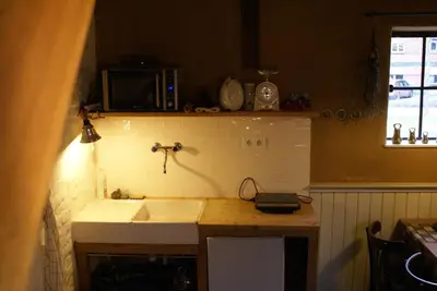 a kitchen with a sink and a microwave at B&B De Metstermolen in Sint-Truiden