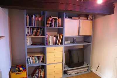 a book shelf with a television in it at B&B De Metstermolen in Sint-Truiden