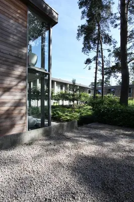 a house with glass windows on the side of it at Hotel De Pits in Heusden - Zolder
