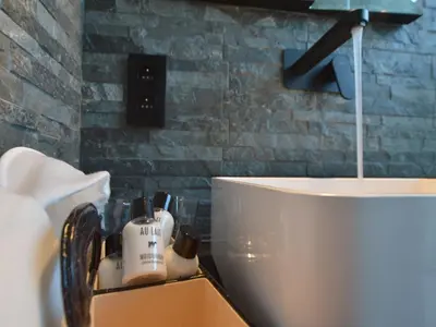 a bathroom with a white toilet and a sink at Cozy Villa in Dalhem Ardennes with Private Garden in Dalhem