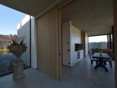 a living room with a table and a large window at Cozy Villa in Dalhem Ardennes with Private Garden in Dalhem