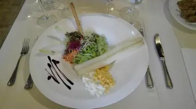 a plate of food with rice and vegetables on a table at Hotel Hooghuys in Hamont-Achel