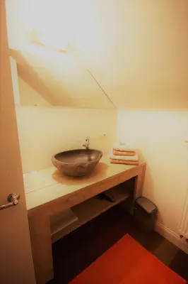 a bathroom with a bowl sink on a table at B&B Crijbohoeve in Zutendaal