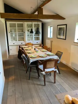 a dining room with a table with chairs and a tableablish at B&B Crijbohoeve in Zutendaal