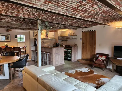 a living room with a couch and a table at B&B Crijbohoeve in Zutendaal