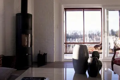 a living room with a couch and a large window at My Secret Garden in Diepenbeek