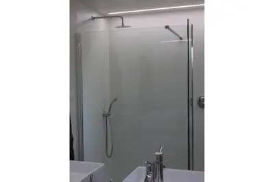 a shower with a glass door in a bathroom at My Secret Garden in Diepenbeek