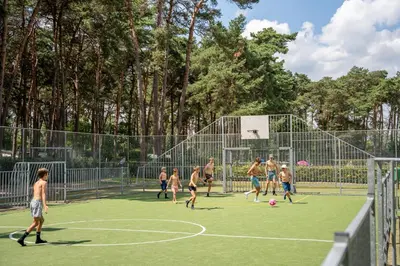 a group of people playing soccer on a court at Familiepark Goolderheide in Bocholt