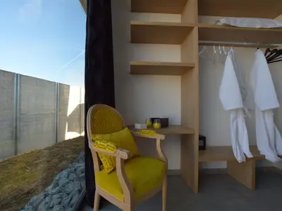 a room with a yellow chair in a bedroom at Modern Dalhem Villa with Views in Dalhem