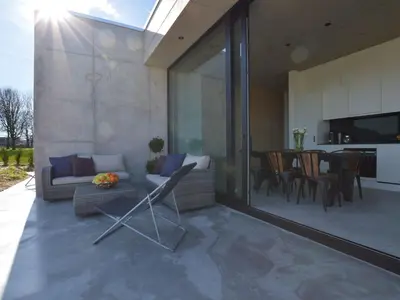 a living room with a couch and a dining room at Modern Dalhem Villa with Views in Dalhem