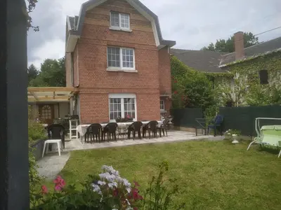 a house with a table and chairs in the yard at Julienne5 in Blégny