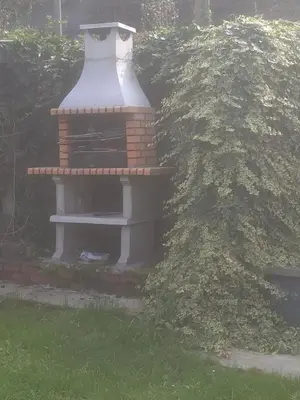 a small bird house sitting in the grass at Julienne5 in Blégny