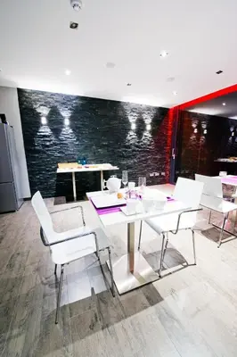 a dining room with a white table and chairs at B&B Villa Curtricias in Kortessem