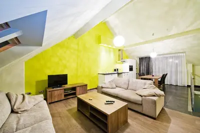 a living room with a couch and a table at B&B Villa Curtricias in Kortessem