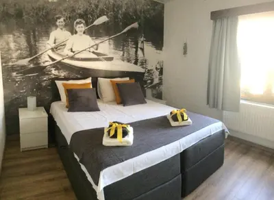a bedroom with a bed with two bags on it at Villa van Brienen in Dilsen-Stokkem