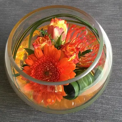 a glass bowl filled with flowers in a bowl at Villa van Brienen in Dilsen-Stokkem