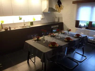 a kitchen with a table with plates and glasses on it at Villa van Brienen in Dilsen-Stokkem
