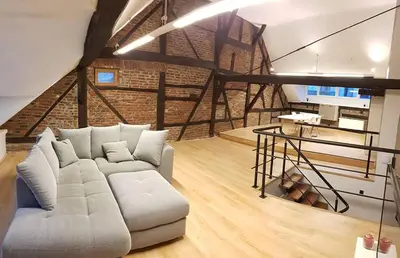 a living room with a white couch in a loft at The Mind Box in Liège