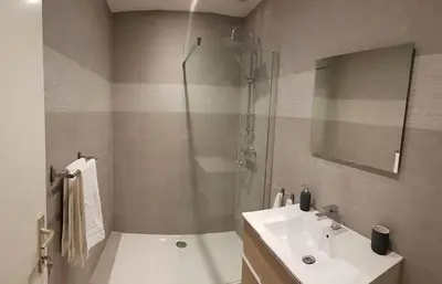 a bathroom with a shower and a sink and a toilet at The Mind Box in Liège
