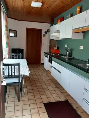 a kitchen with a table and a table and a dining room at Vakantiewoning Het Oude Laer in Bilzen