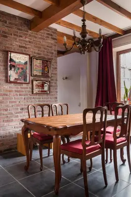 a dining room with a wooden table and chairs at Vakantiewoning Het Oude Laer in Bilzen