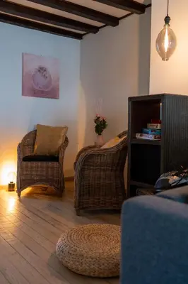 a living room with two chairs and a couch at De Mandenvlechter in Dilsen-Stokkem